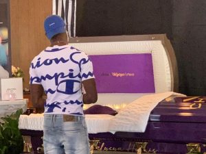 Caption: A mourner stands over the casket of Felycya (Antuan) Harris, who was found dead Oct. 3 at Meadowlark Park. The case remains unsolved. (Credit: Facebook - Celebration of Life Funeral Home)