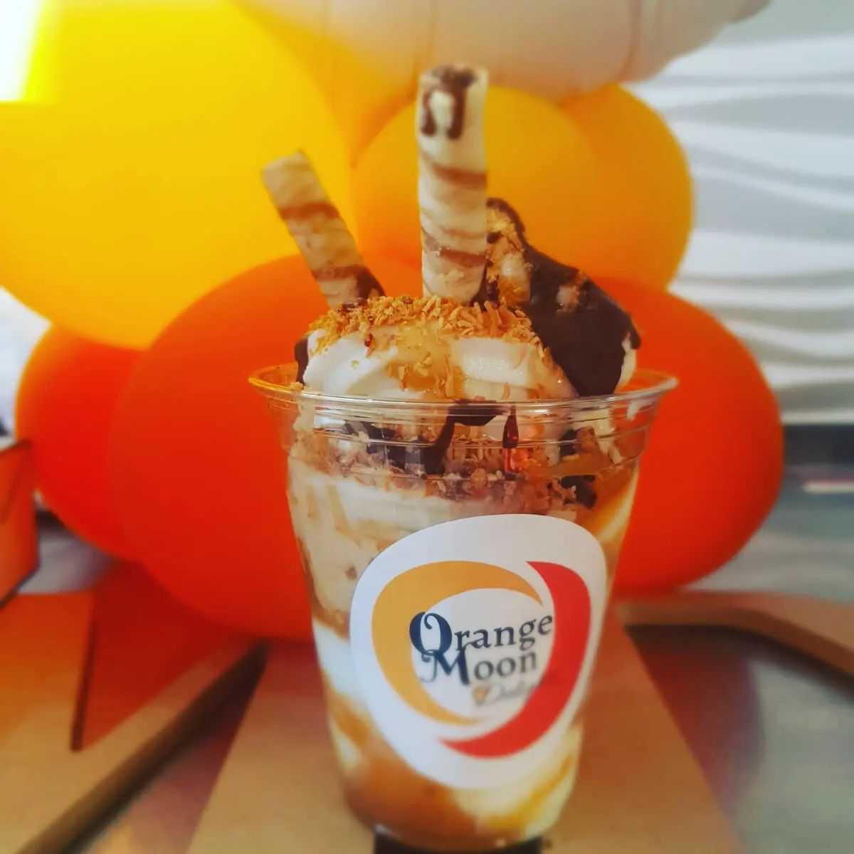 Orange Moon Delights offers gourmet desserts and a community